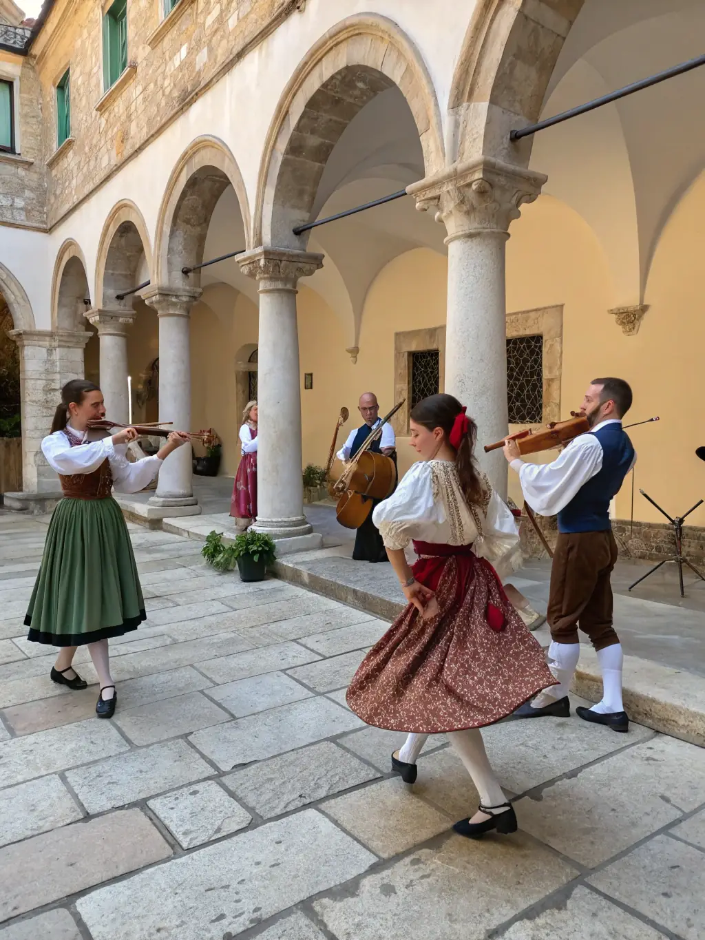 A vibrant image of a cultural event held in the gardens of Château de Quintin, featuring traditional music and dance performances.